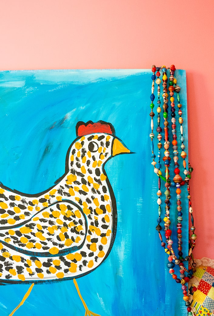 Folk painting of a chicken, part of a playful chick-themed collection at Martha Chang’s office 