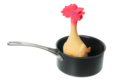 Toy rubber chicken in a frying pan, representing a digital design or web development company needing expert content help