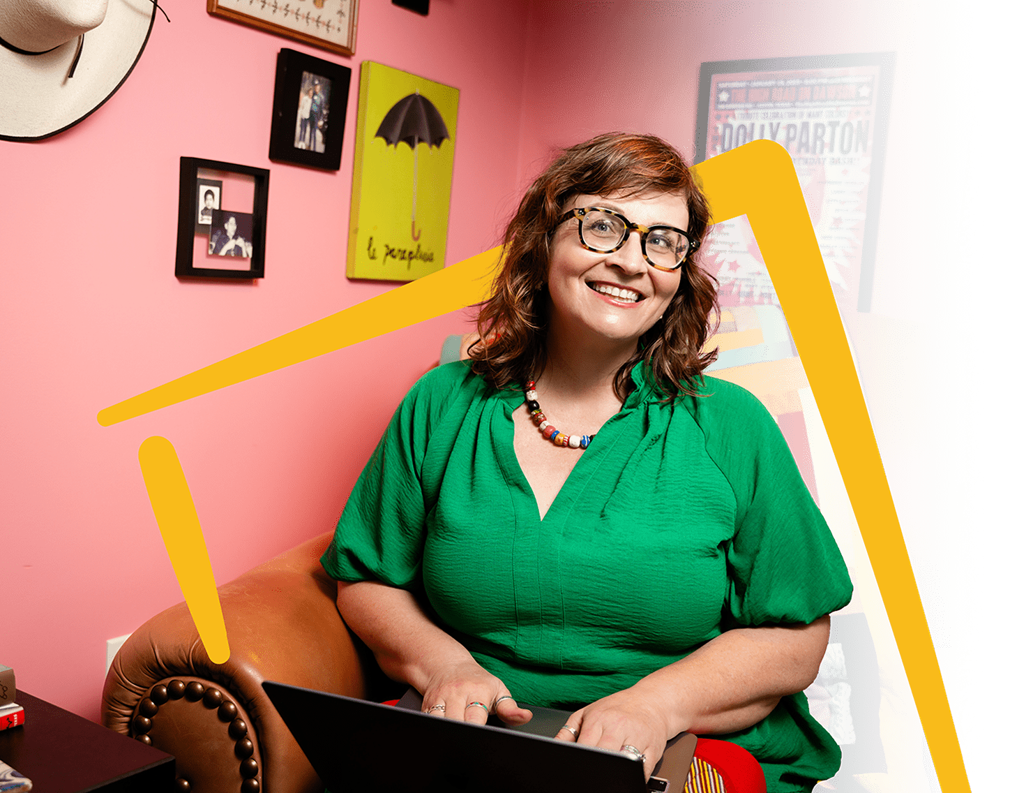 Martha Chang, freelance copywriter & voice talent, on the couch in her colorful Chick Creative workspace, smiling brightly